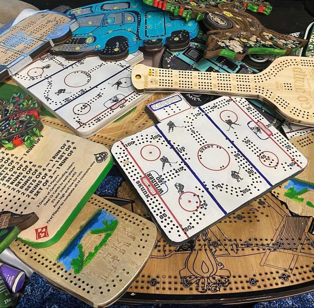 Collection of wooden cribbage boards.