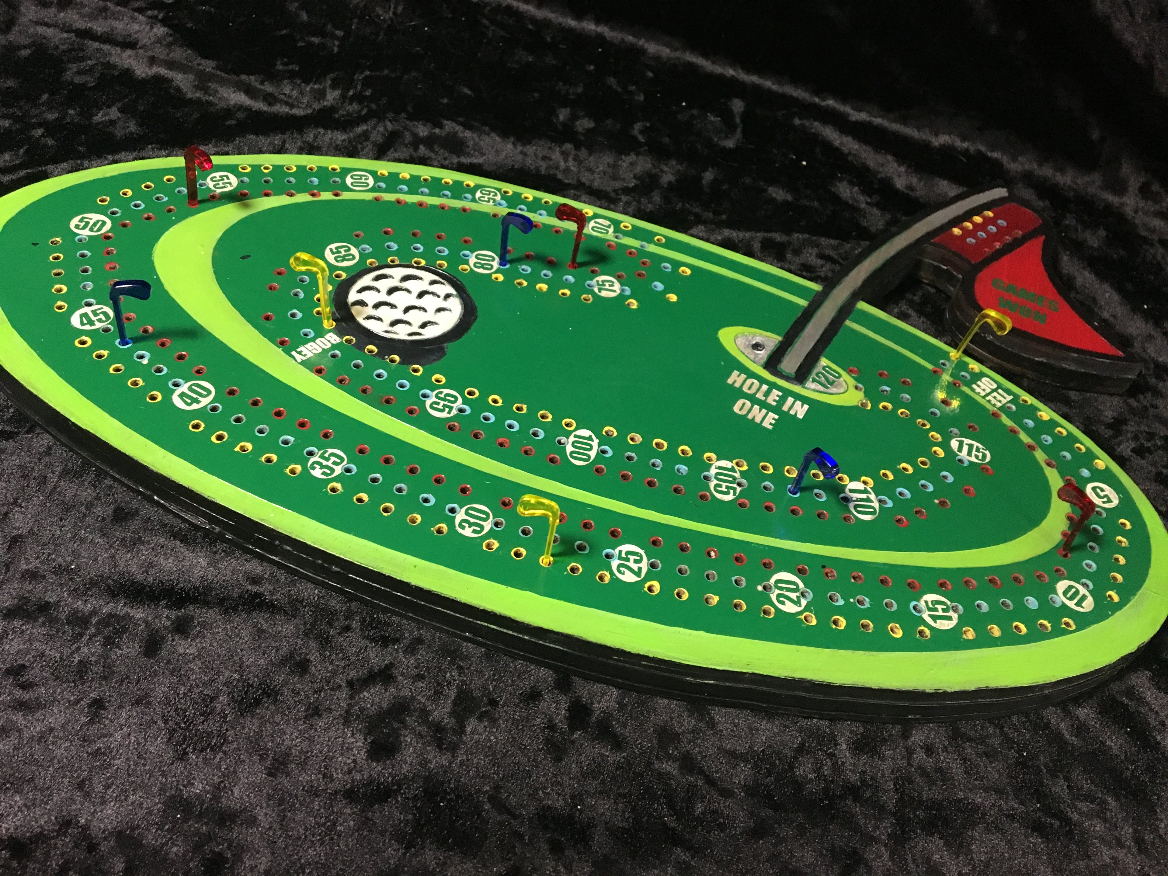 Golf themed cribbage board with acrylic pegs.