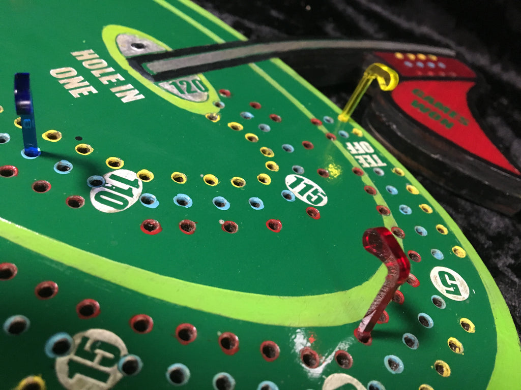 Golf themed cribbage board with acrylic pegs.