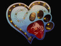 Decorative heart-shaped cribbage board with paw print design and dog engraving.