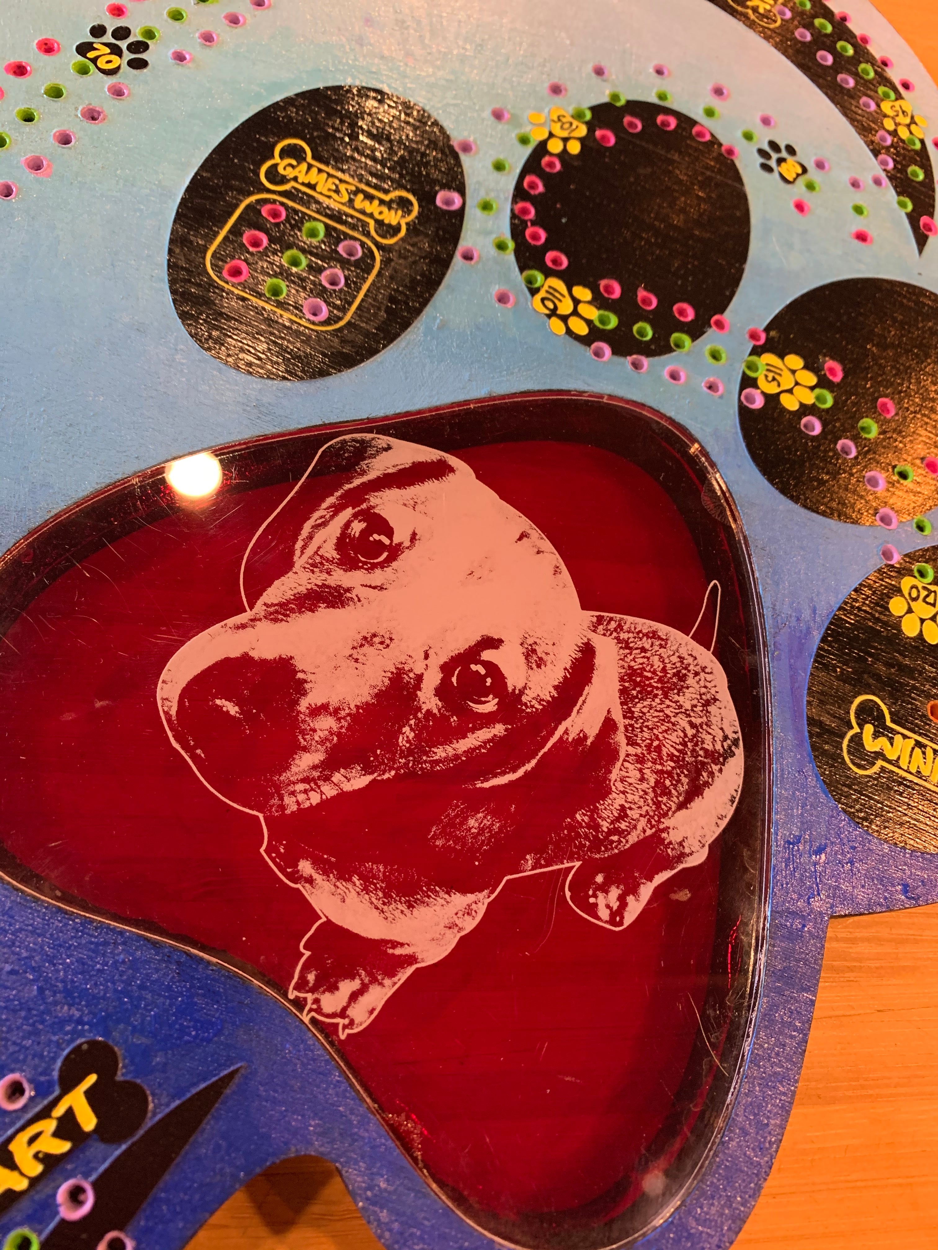 Decorative heart-shaped cribbage board with paw print design and dog engraving.