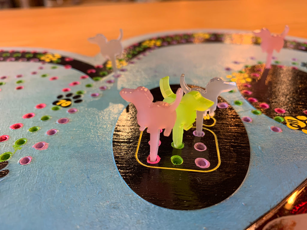 Colorful acrylic dog pegs on a cribboard game.