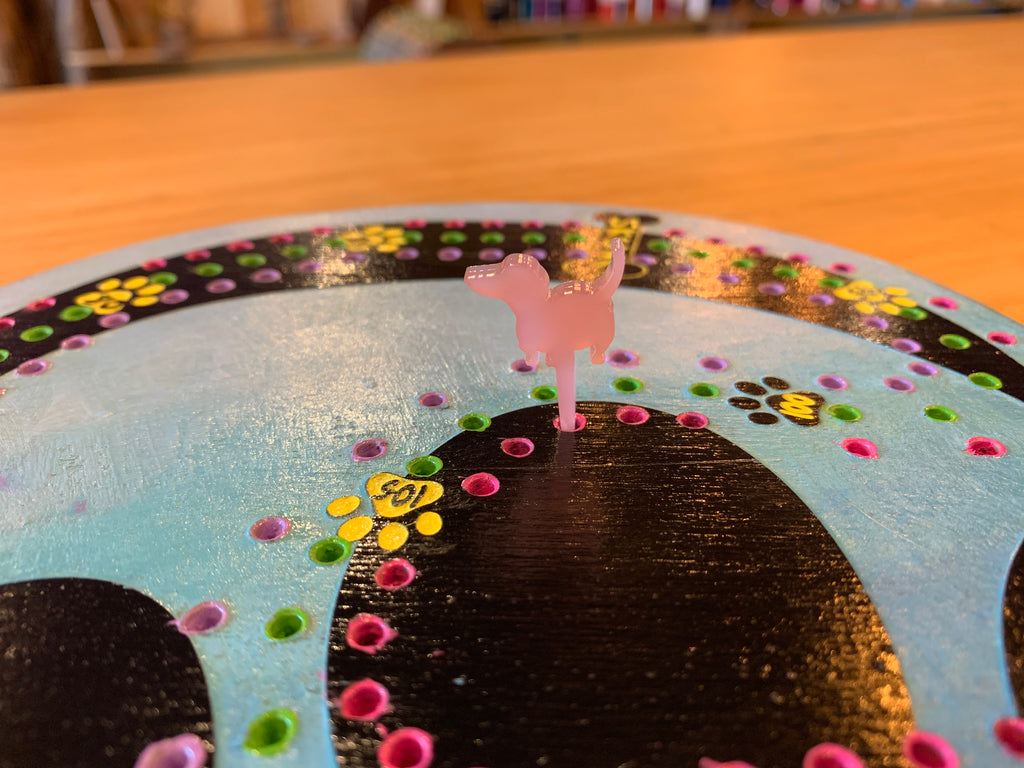 Colorful acrylic dog pegs on a cribboard game.