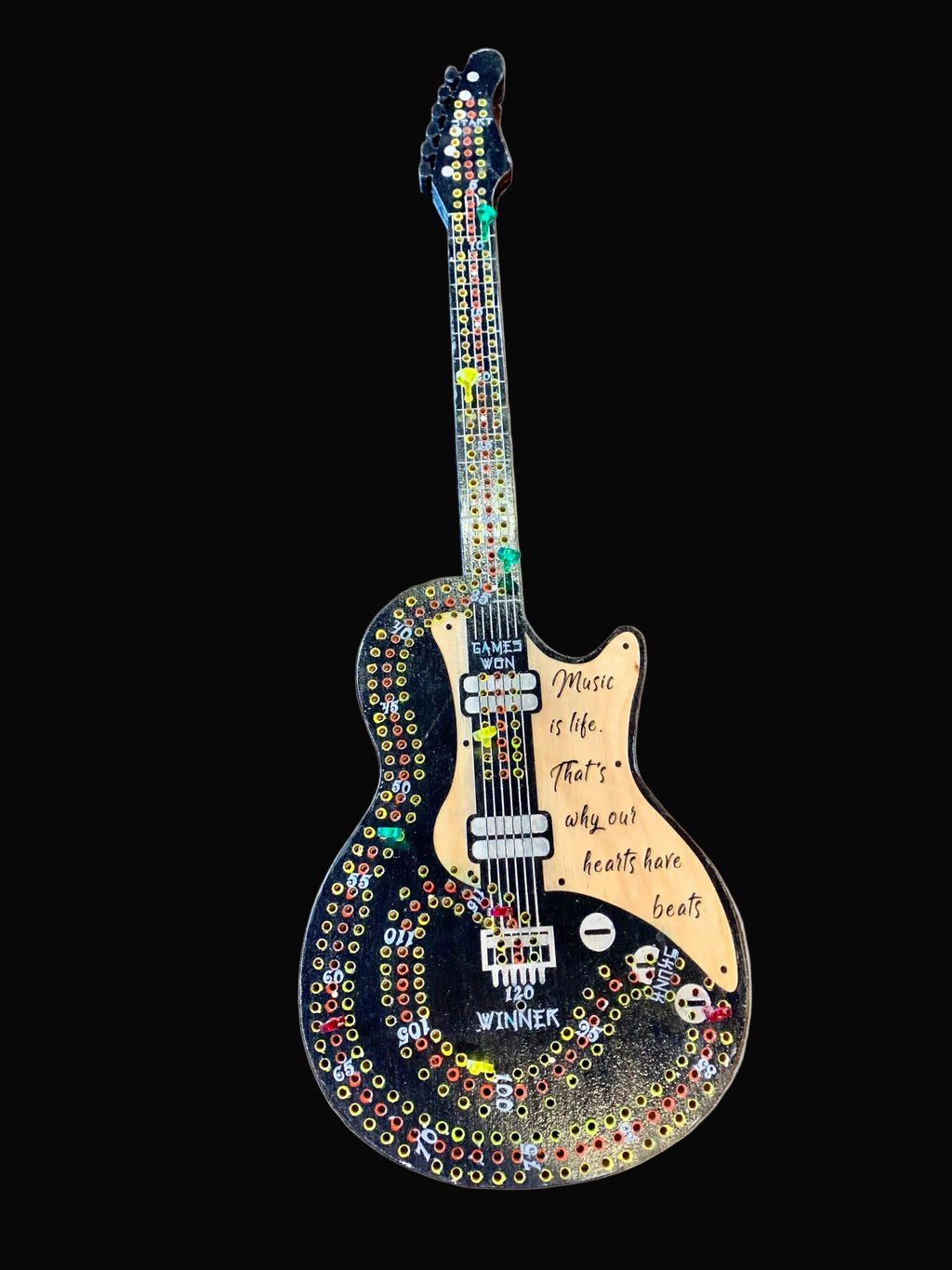 Decorative guitar cribbage board hand painted on a wooden surface