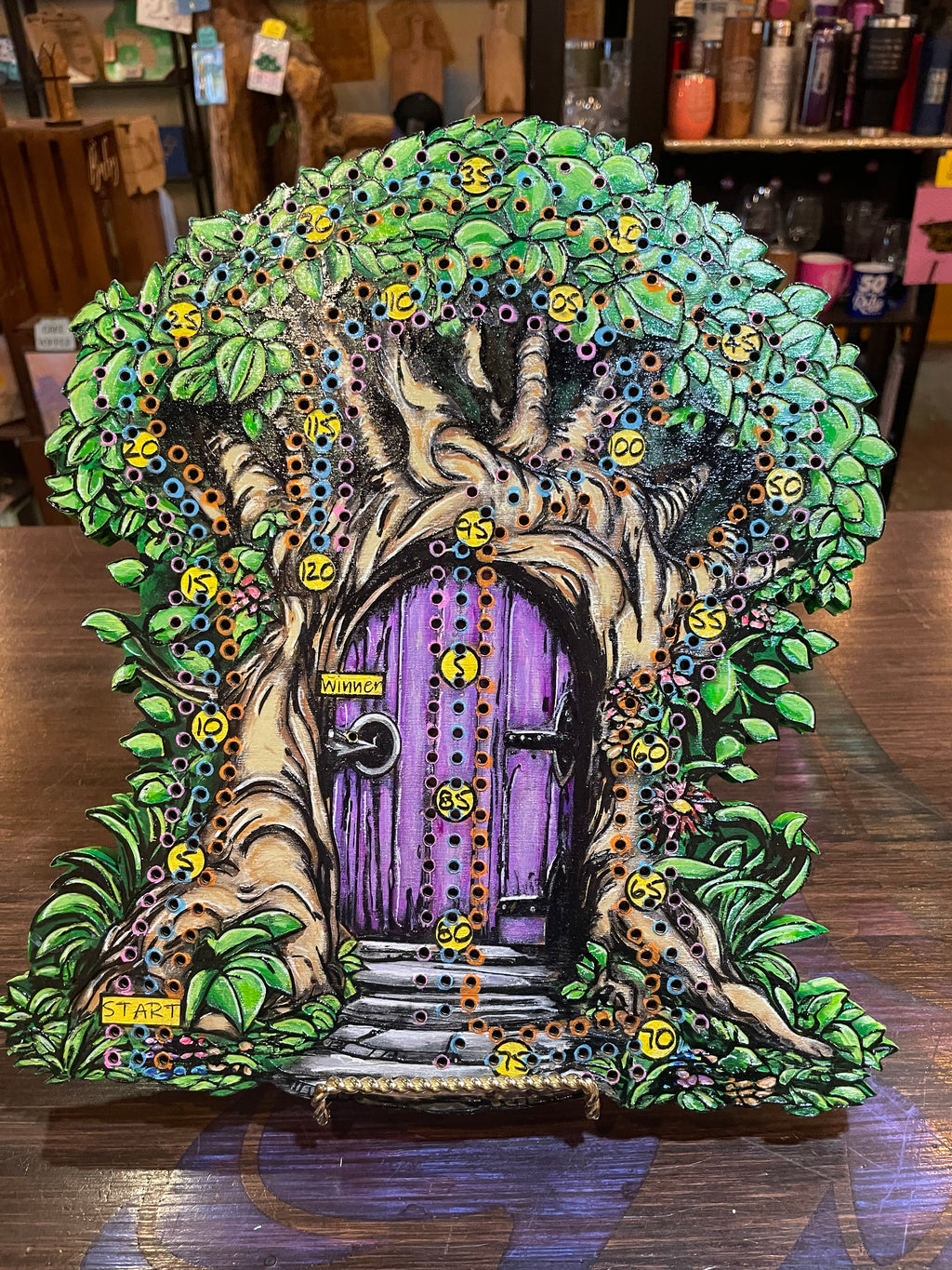 Fantasy door in a tree with purple door and greenery on a crib board