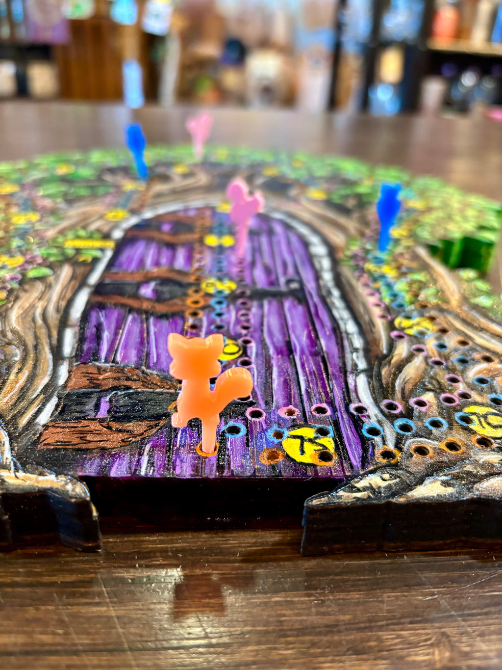 Board game piece on a colorful board with a purple door