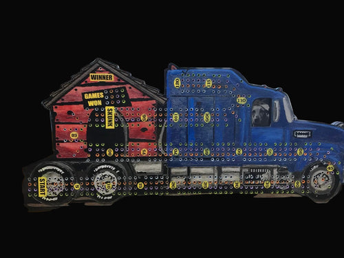Cribbage board of a blue truck with a dog inside and dog house on the back.