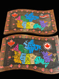 Two decorative wooden crib boards with colorful text and designs on a wooden surface.