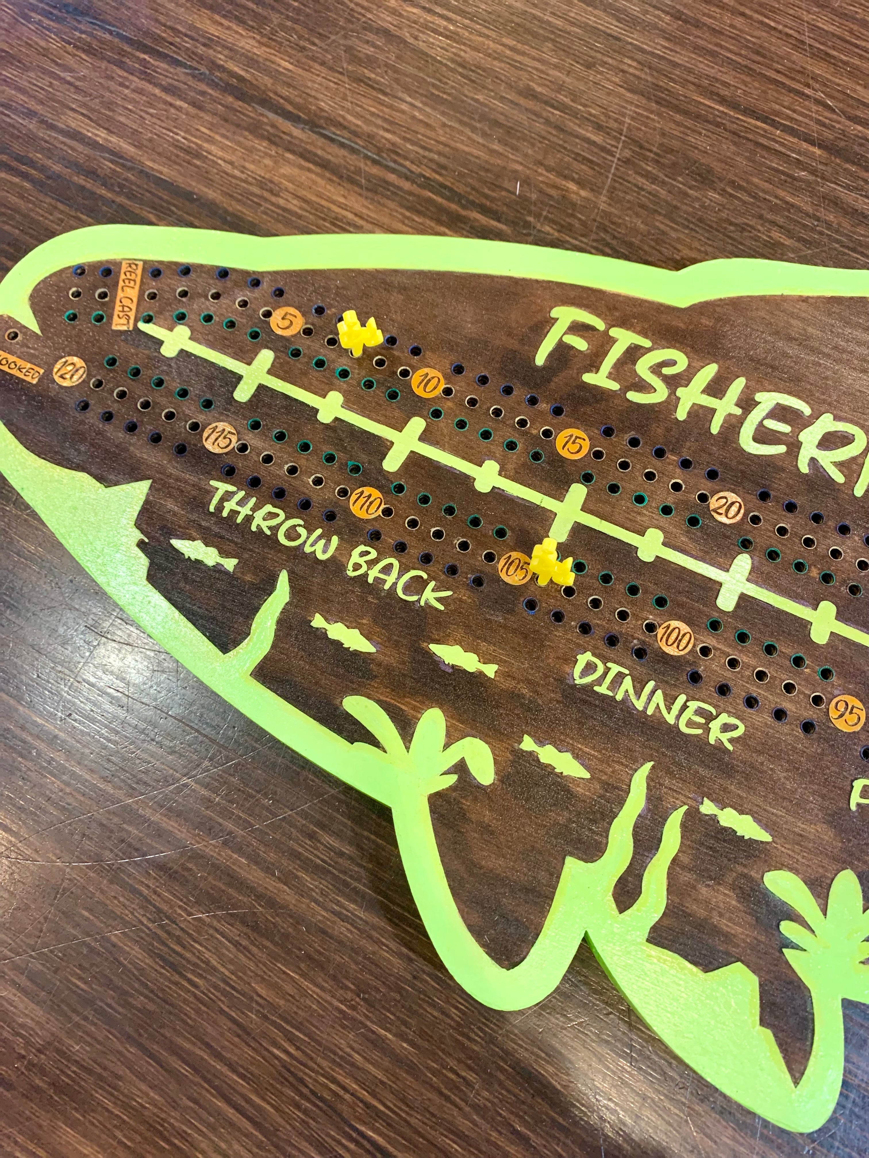 Wooden crib board with fishing-themed design.