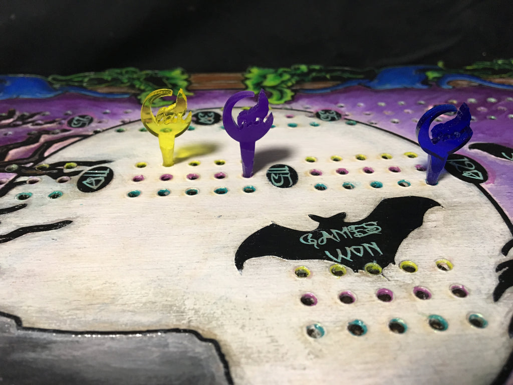 Cribbage board with colorful pegs on a decorative background