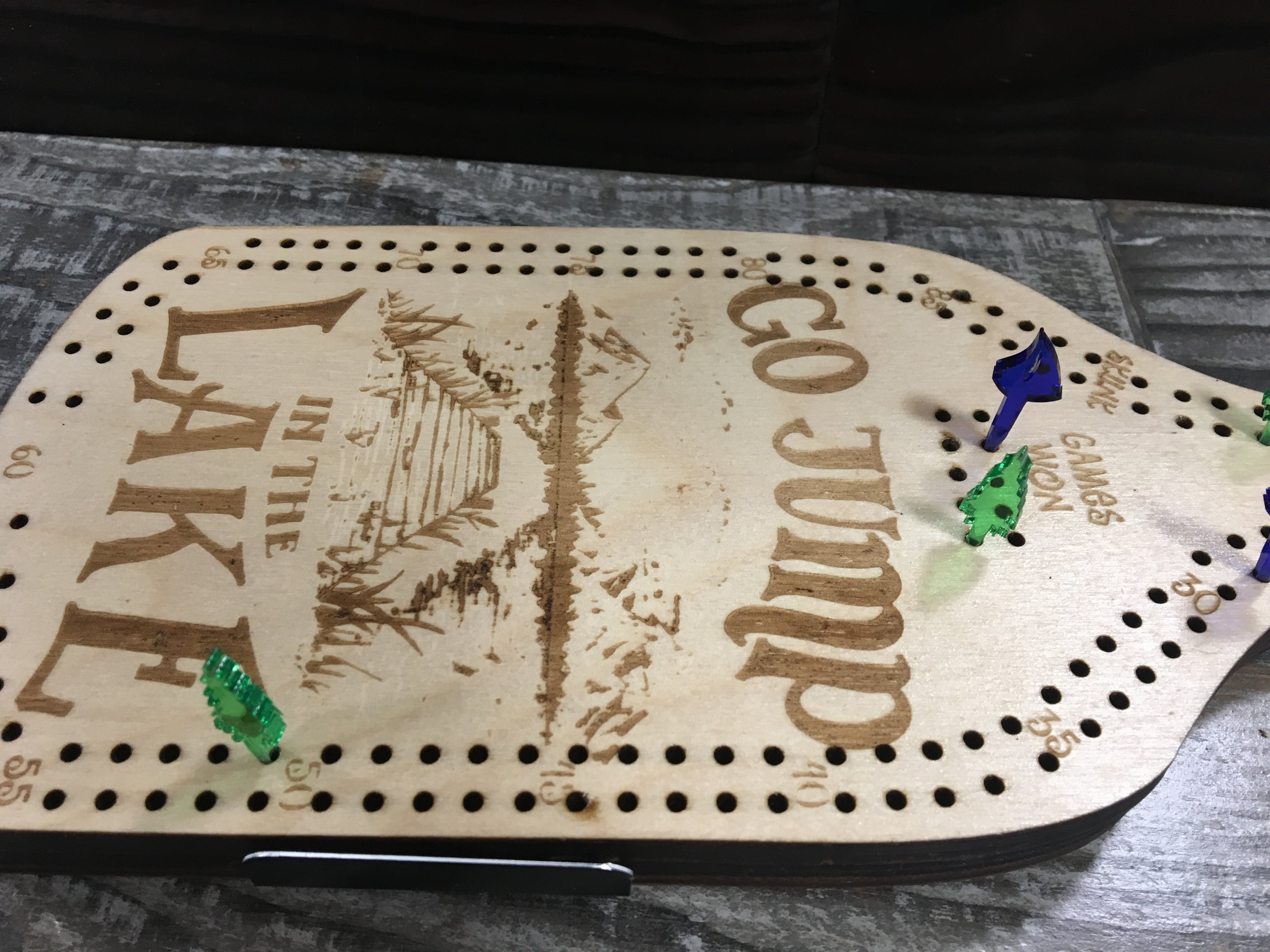 Cribbage board with "Jump to the Lake".