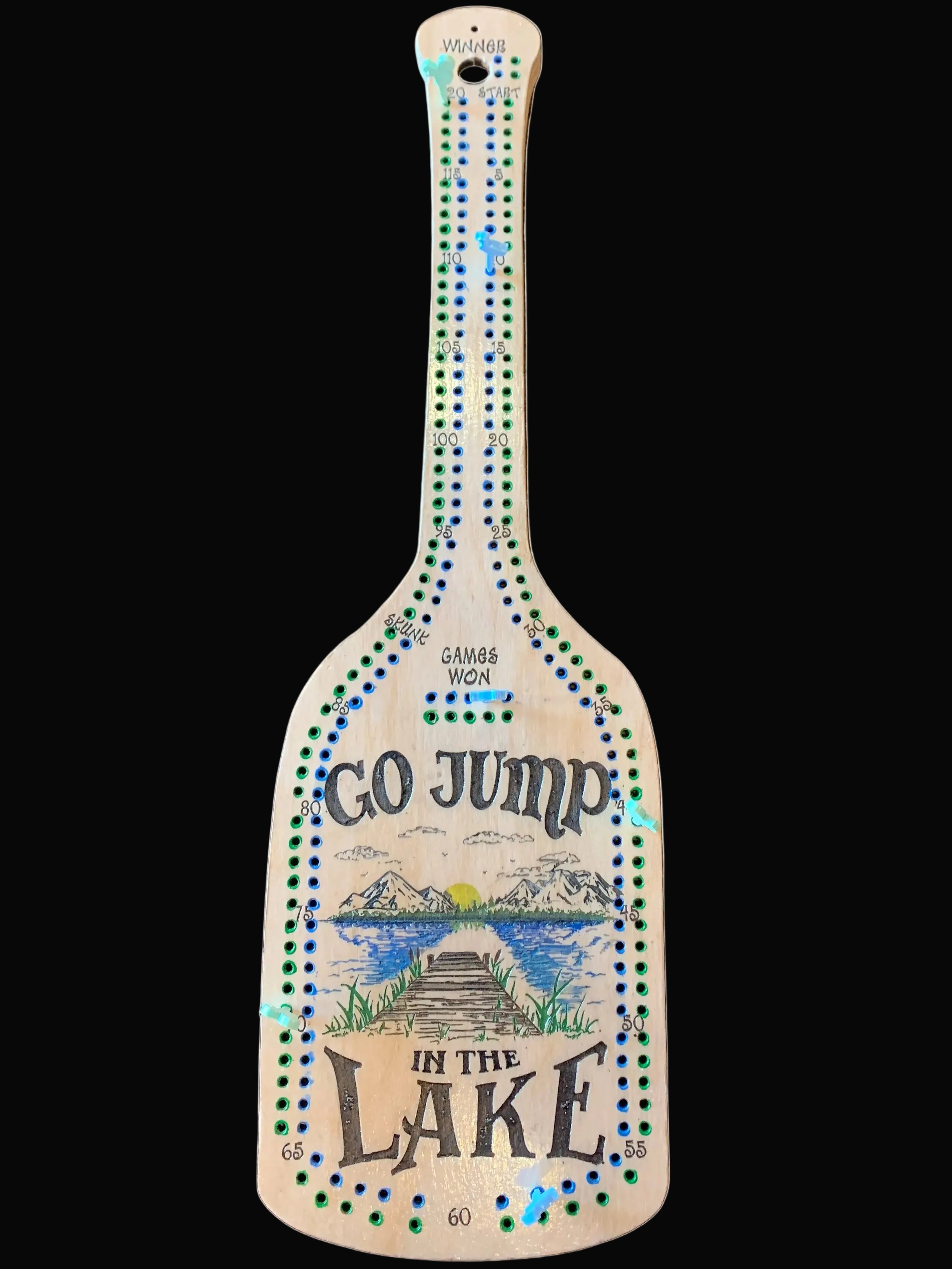 Wooden paddle cribbage board with "At the Lake".