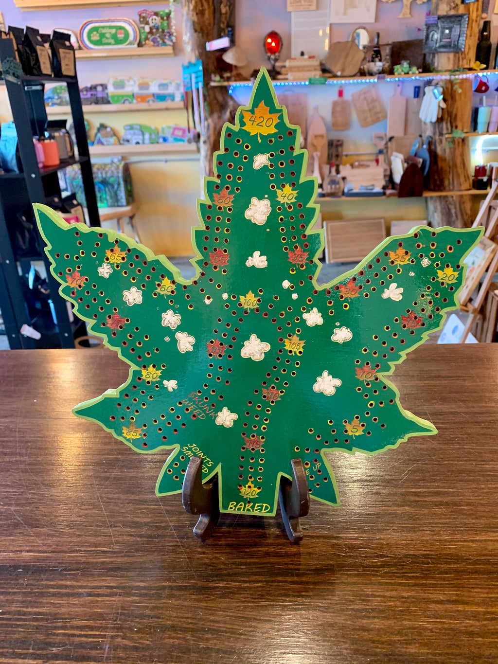 Decorative cannabis leaf cribbage board.