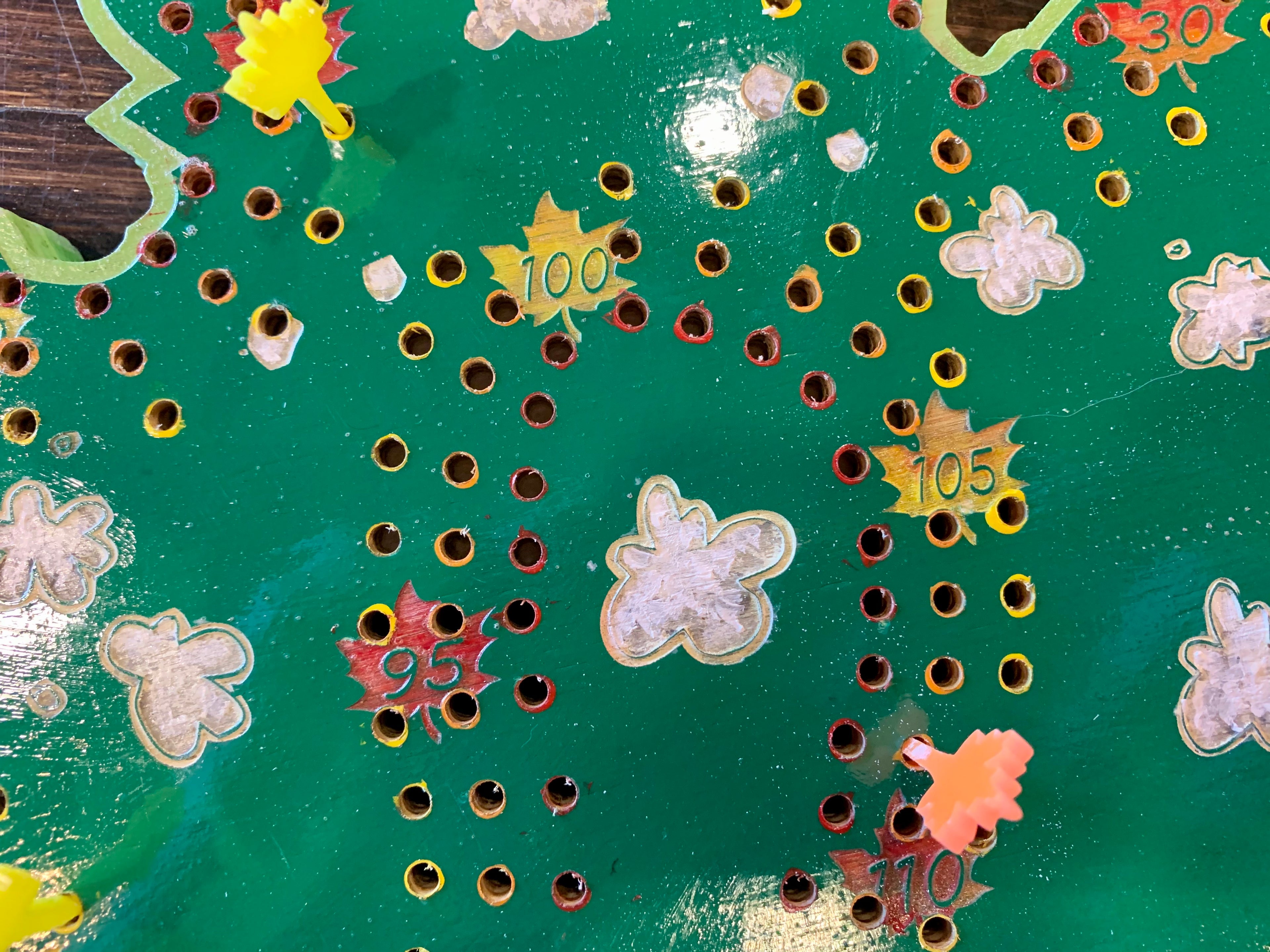 Close-up of a green crib board with smoke and numbers.