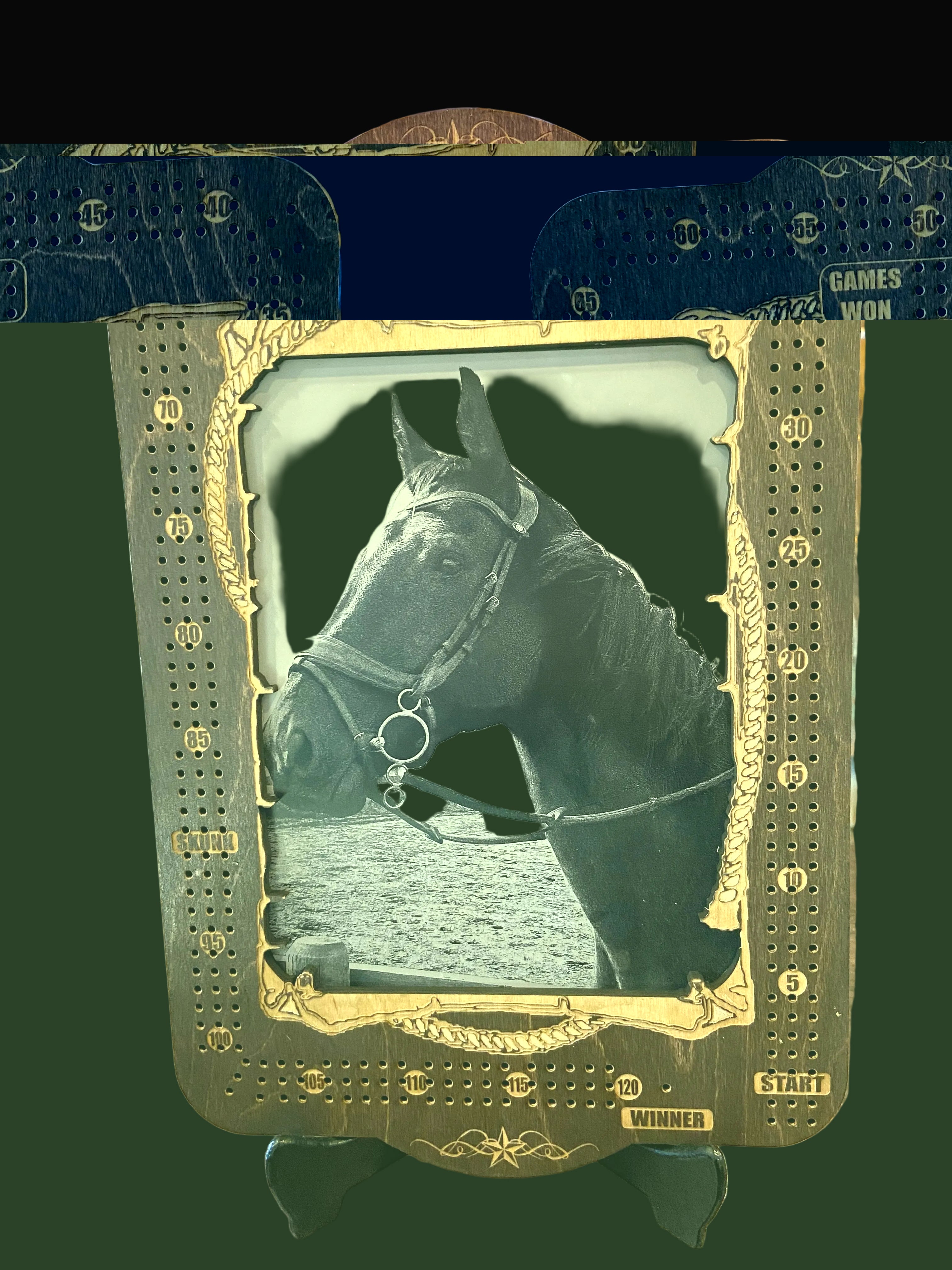 Cribbage board with a horse head design on a wooden surface