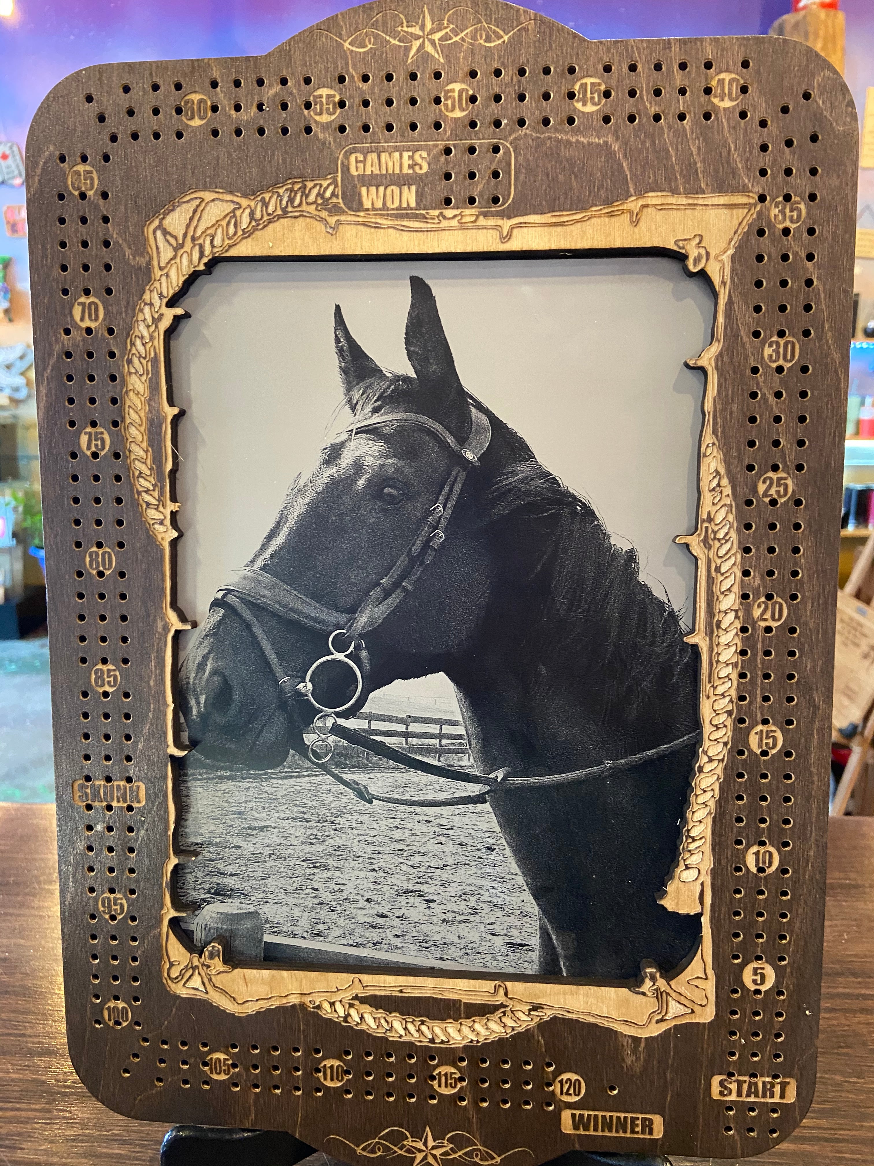 Vintage-style photo of a horse in a decorative frame with intricate details.